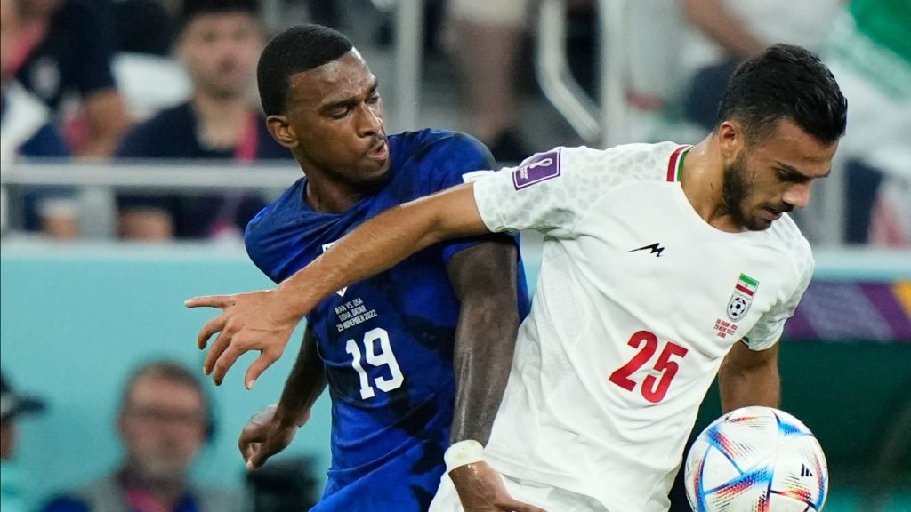 Haji Wright centre-forward of USA and Antalyaspor and Abolfazl Jalali left-back of Iran and Esteghlal FC compete for the ball during the FIFA World Cup Qatar 2022 Group B match between IR Iran and USA